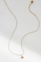 A model wearing size OneSize of the North Star Necklace in colour Gold (Metallics), from the front, showing the whole outfit