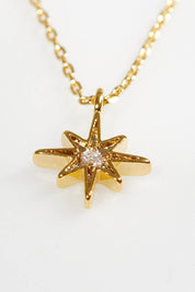 A model wearing size OneSize of the North Star Necklace in colour Gold (Metallics), from the front, showing the whole outfit