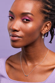 A model wearing the Multi Heart Beaded Necklace in colour Silvergold (Metallics), from the front, cropped image