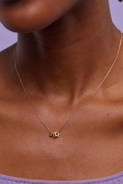 A model wearing the Multi Flower Beaded Necklace in colour Goldsilver (Metallics), from the front, cropped image