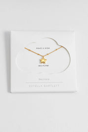 A model wearing the Hand Drawn Star Pendant On Beaded Chain in colour Gold (Metallics), from the front, showing the whole outfit