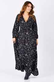 Model Laura wearing size M of the Luna Dress in colour MarbleBlac (Black), from the front, showing the whole outfit