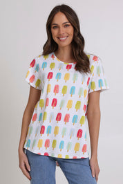 Model Madeline wearing size S of the Here Comes The Summer Cotton Tee in colour Icy, from the front, cropped image