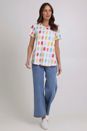 Model Madeline wearing size S of the Here Comes The Summer Cotton Tee in colour Icy, from the front, showing the whole outfit