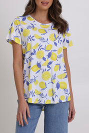Model Madeline wearing size S of the Here Comes The Summer Cotton Tee in colour Zestlife, from the front, cropped image