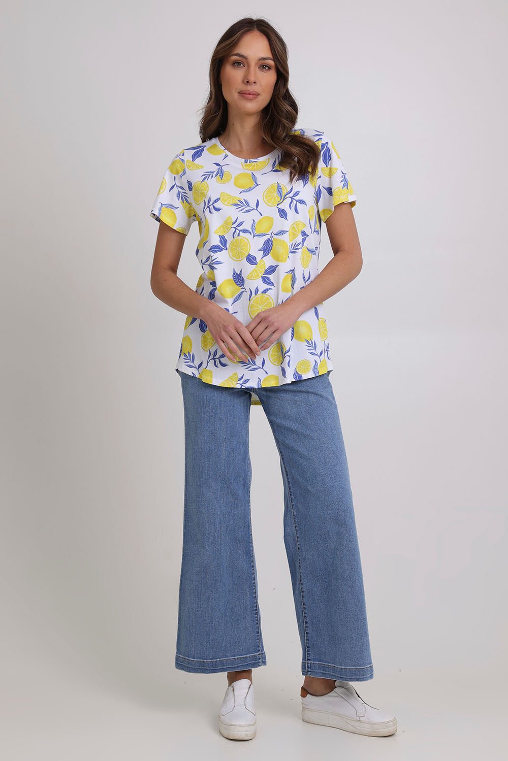 Model Madeline wearing size S of the Here Comes The Summer Cotton Tee in colour Zestlife, from the front, showing the whole outfit