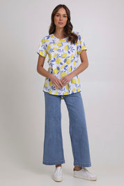 Model Madeline wearing size S of the Here Comes The Summer Cotton Tee in colour Zestlife, from the front, showing the whole outfit
