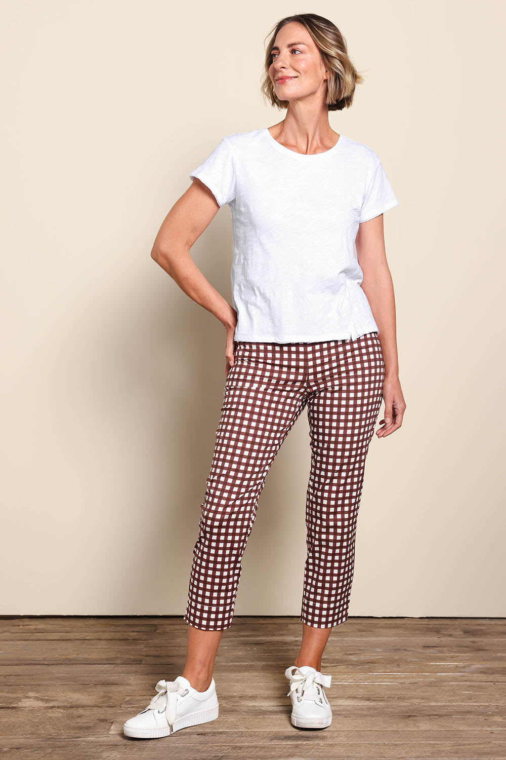 Model Riinar wearing size 10 of the Fuss Free Cotton Blend Taper Capri Trapeze Pant – Checkit in colour Checkit, from the front