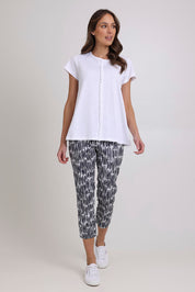 Model Madeline wearing size 10 of the Fuss Free Cotton Blend Taper Capri Trapeze Pant in colour Code (Black), from the front, showing the whole outfit