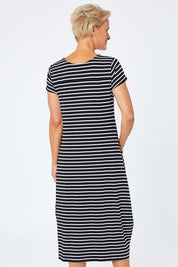 Model Amelia wearing size S of the Pocket Rocket Dress in colour Navwhistri (Blue), from the back