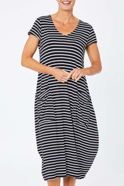 Model Amelia wearing size S of the Pocket Rocket Dress in colour Navwhistri (Blue), from the front, cropped image