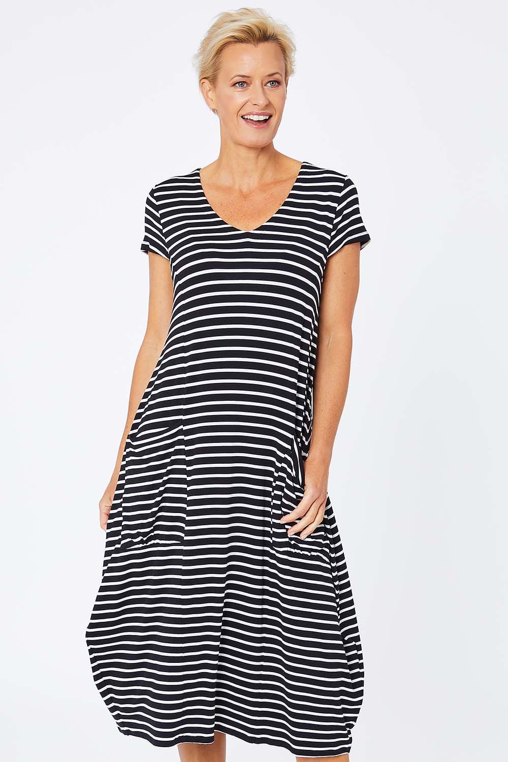 Model Amelia wearing size S of the Pocket Rocket Dress in colour Navwhistri (Blue), from the front, cropped image