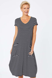 Model Amelia wearing size S of the Pocket Rocket Dress in colour Navwhistri (Blue), from the front, cropped image
