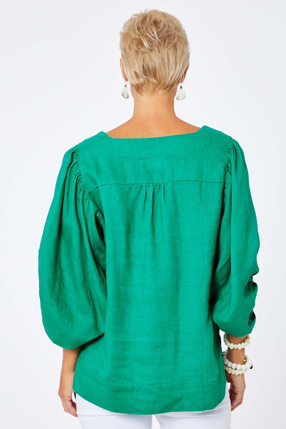 Model Amelia wearing size 10 of the Blow Me Away Linen Top in colour Jade (Green), from the back