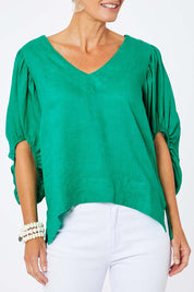 Model Amelia wearing size 10 of the Blow Me Away Linen Top in colour Jade (Green), from the front, cropped image