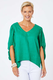 Model Amelia wearing size 10 of the Blow Me Away Linen Top in colour Jade (Green), from the front, cropped image