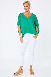 Model Amelia wearing size 10 of the Blow Me Away Linen Top in colour Jade (Green), from the front, showing the whole outfit