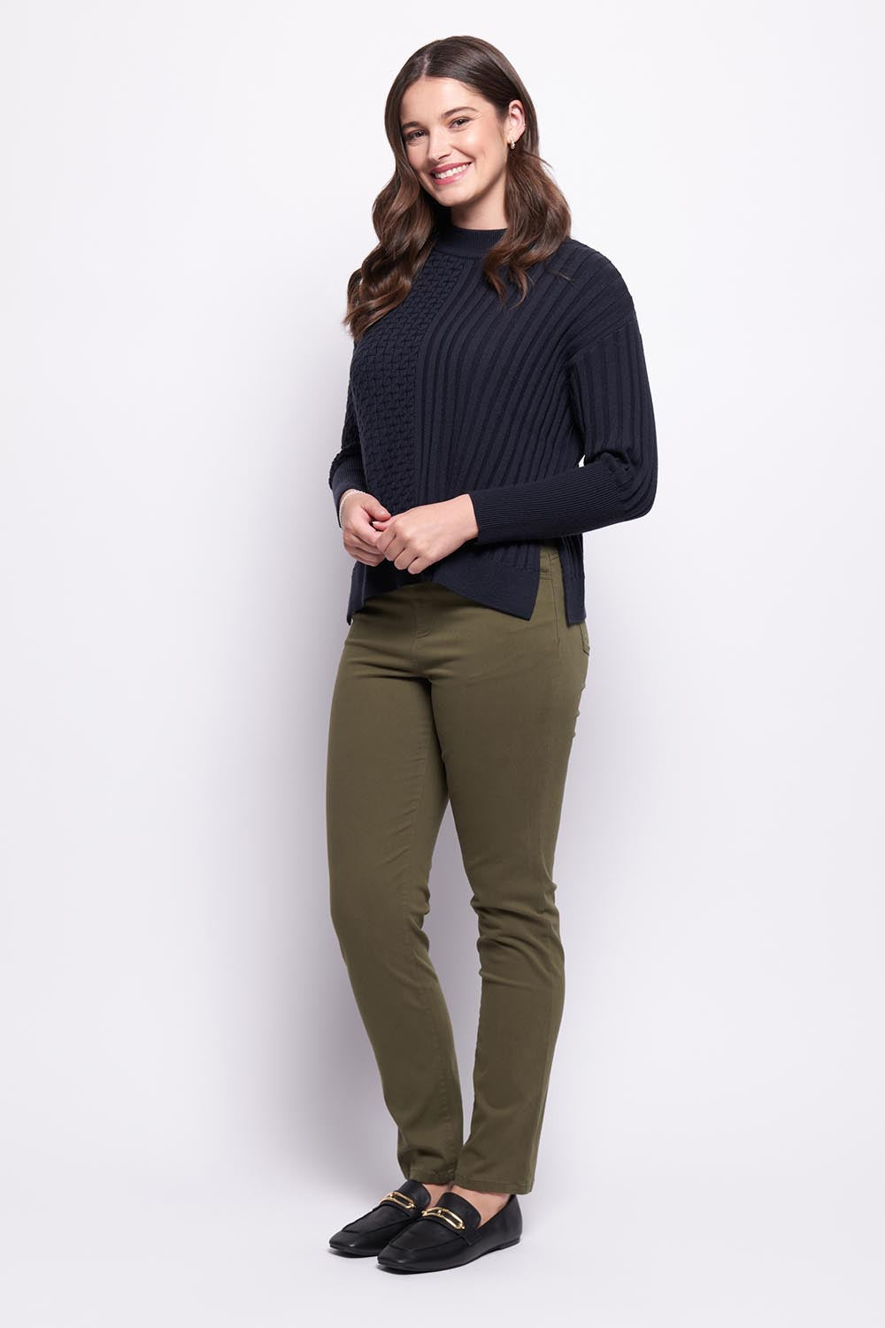 A model wearing the Holey Moleskin Trouser in colour Hunter (Green), from the front, showing the whole outfit