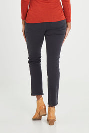 Model Aiyana wearing size 10 of the Holey Moleskin Trouser in colour Truenavy (Blue), from the back