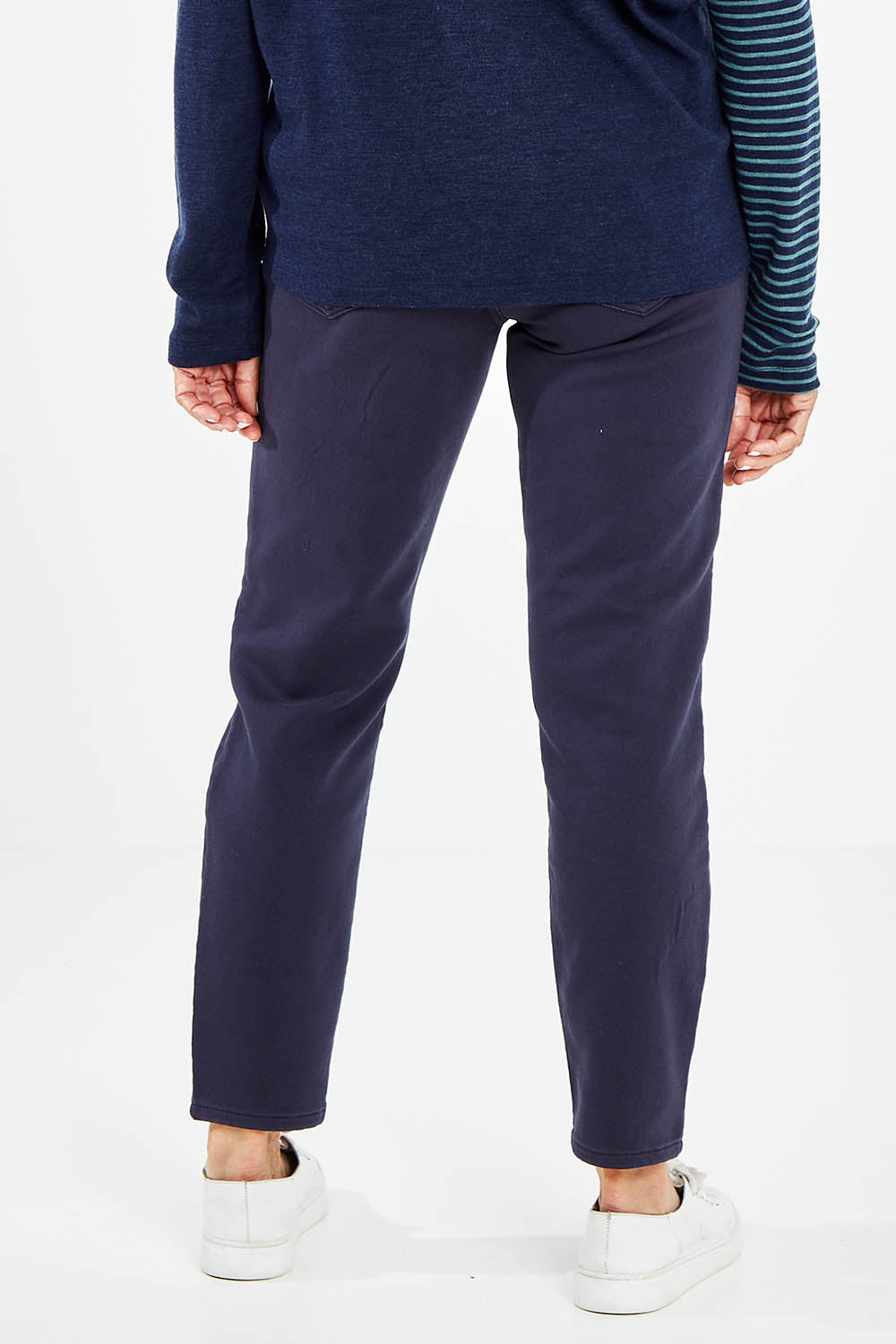Model Elise wearing size 10 of the Final Stretch Jogger in colour Denim (Blue), from the back