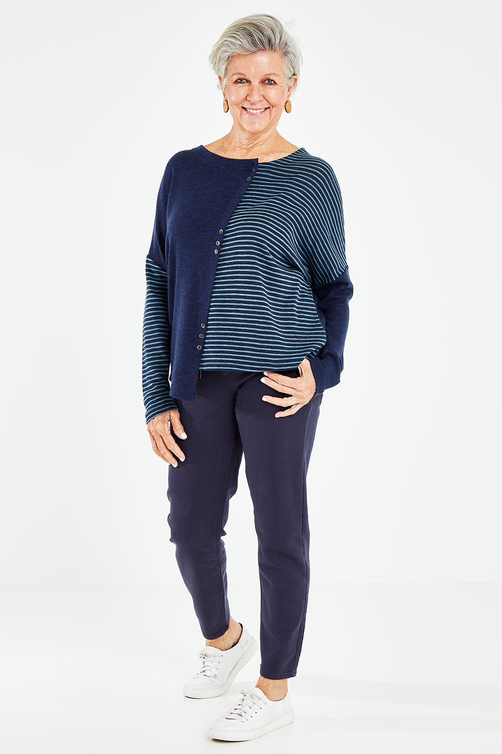 Model Elise wearing size 10 of the Final Stretch Jogger in colour Denim (Blue), from the front, showing the whole outfit