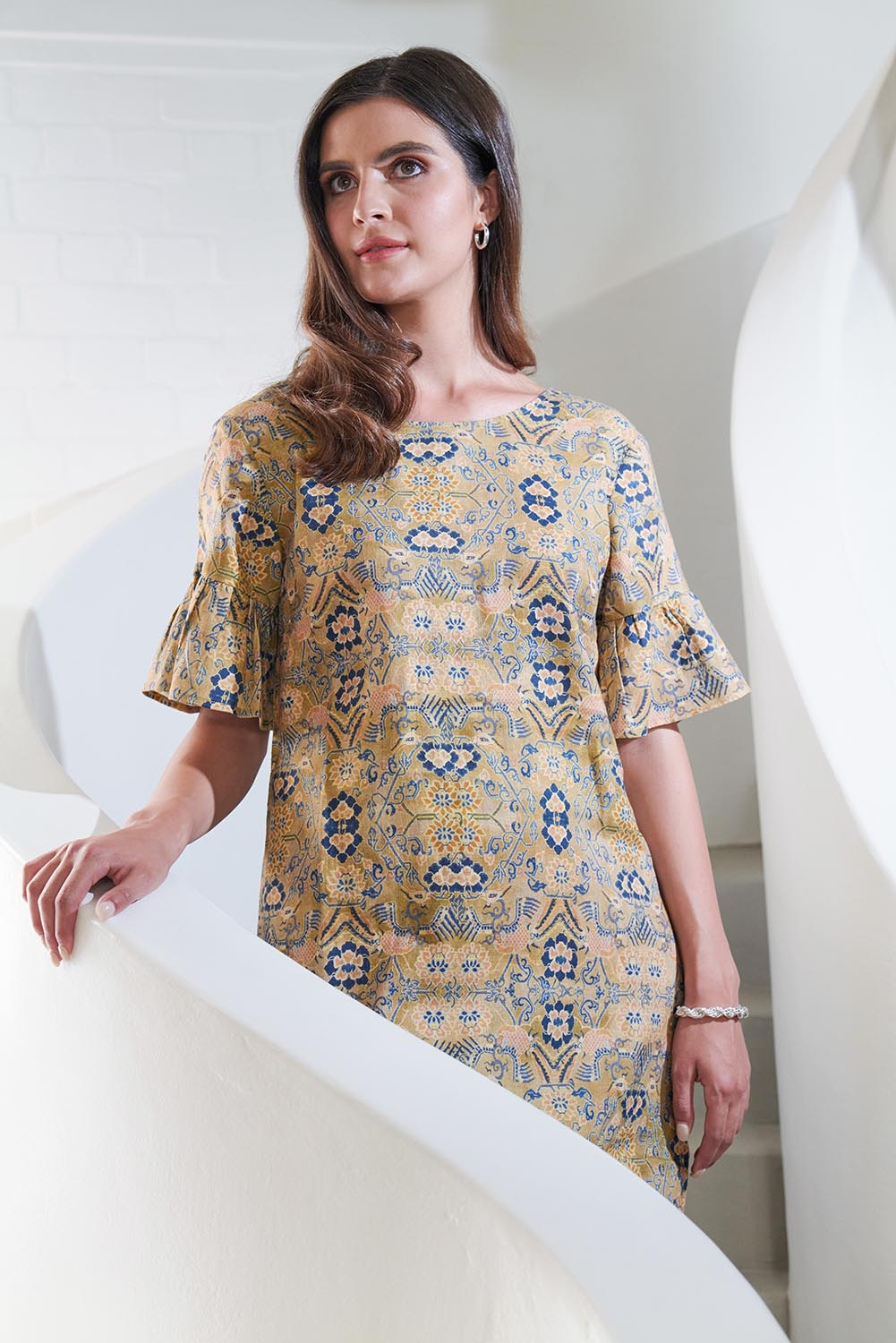 A model wearing the Truly Frilling Linen Dress in colour Ornate, from the front, showing the whole outfit