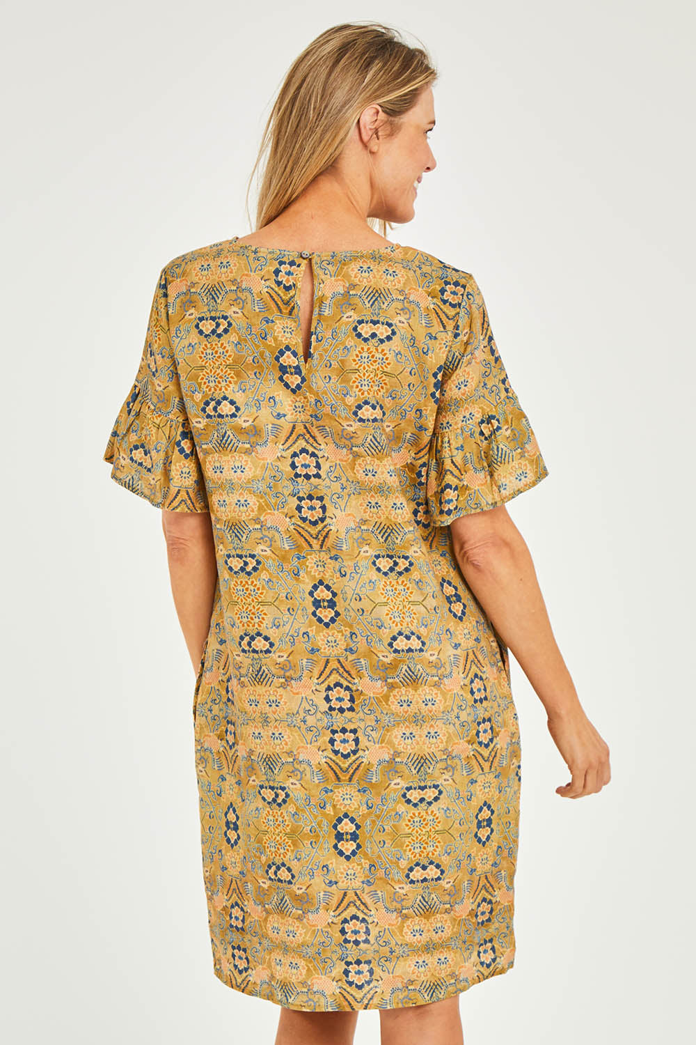 Model Kelly wearing size 10 of the Truly Frilling Linen Dress in colour Ornate, from the back