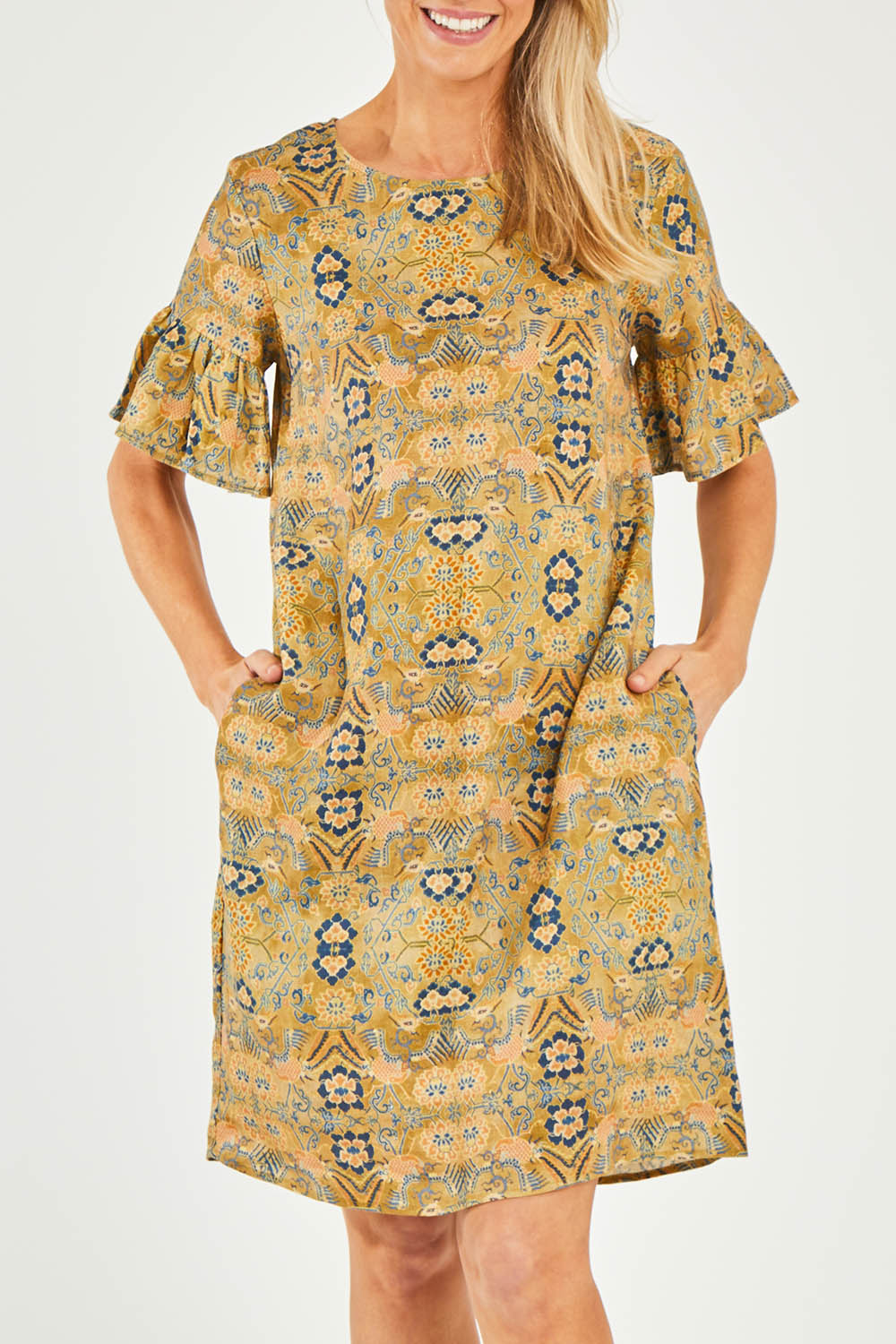 Model Kelly wearing size 10 of the Truly Frilling Linen Dress in colour Ornate, from the front, cropped image