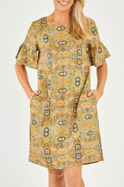Model Kelly wearing size 10 of the Truly Frilling Linen Dress in colour Ornate, from the front, cropped image