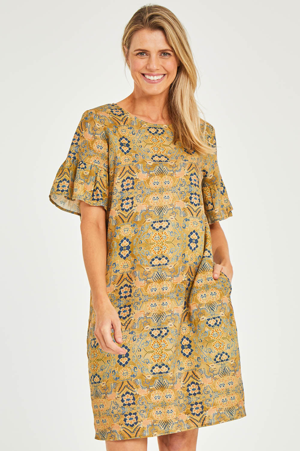 Model Kelly wearing size 10 of the Truly Frilling Linen Dress in colour Ornate, from the front, cropped image