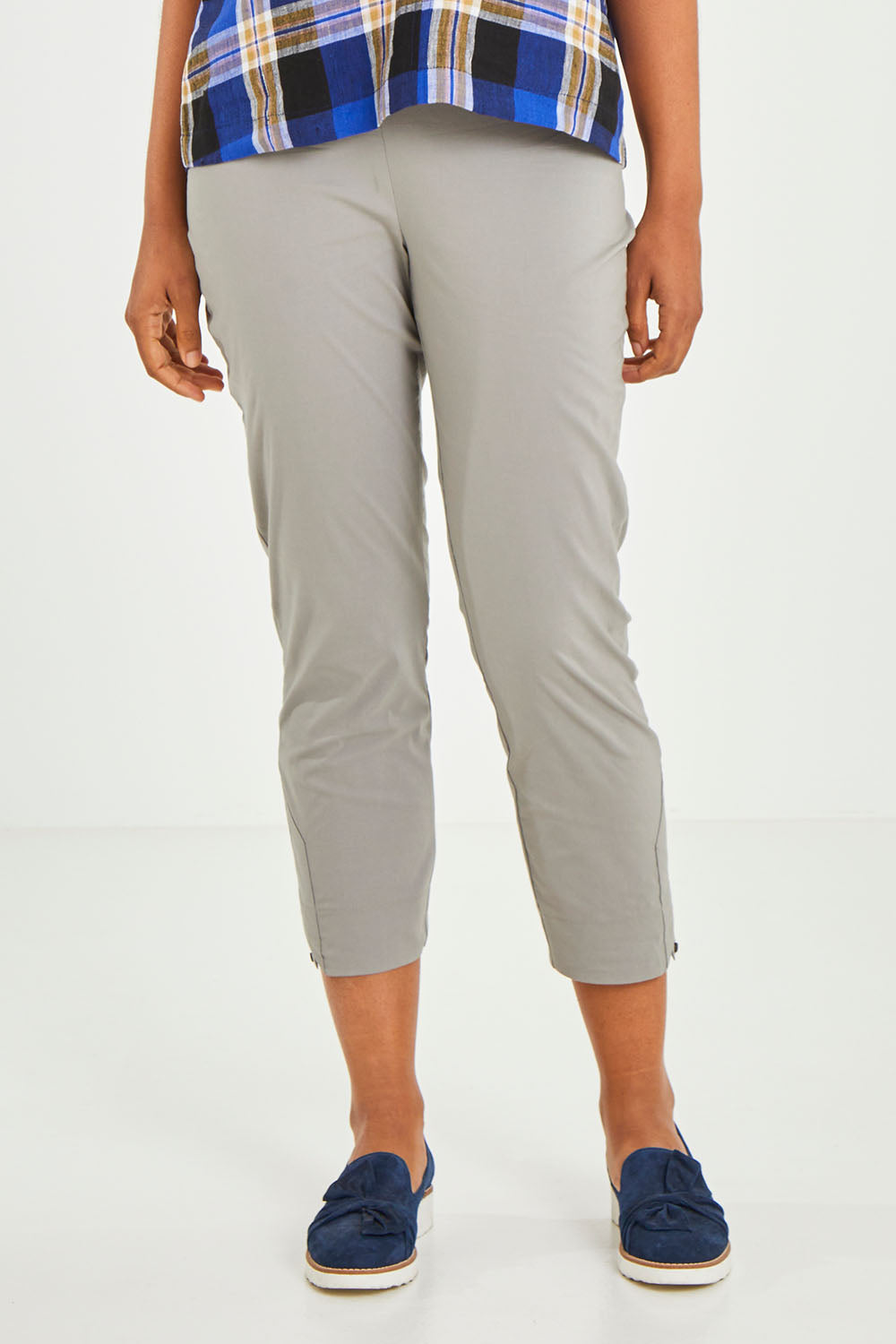Model Olivia wearing size 10 of the Signature 7/8 Taper Trapeze Pant in colour Stone, from the front, cropped image