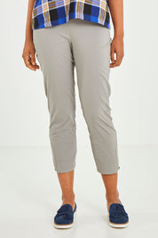 Model Olivia wearing size 10 of the Signature 7/8 Taper Trapeze Pant in colour Stone, from the front, cropped image