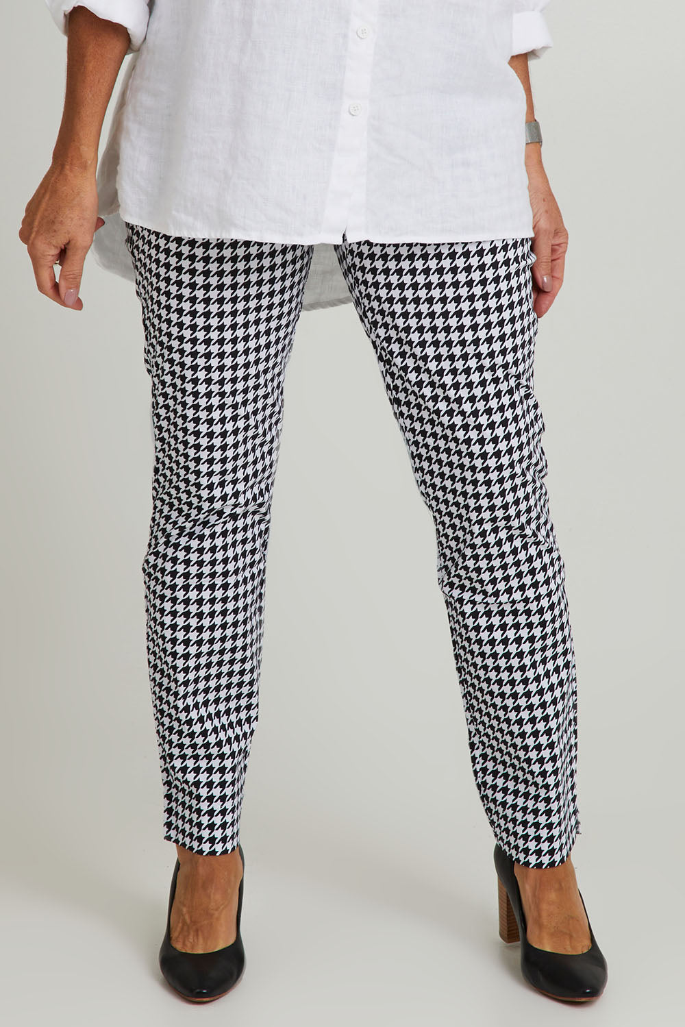 Model Sandy wearing size 10 of the Long Slim Trapeze Pant in colour Hound (Black), from the front, cropped image