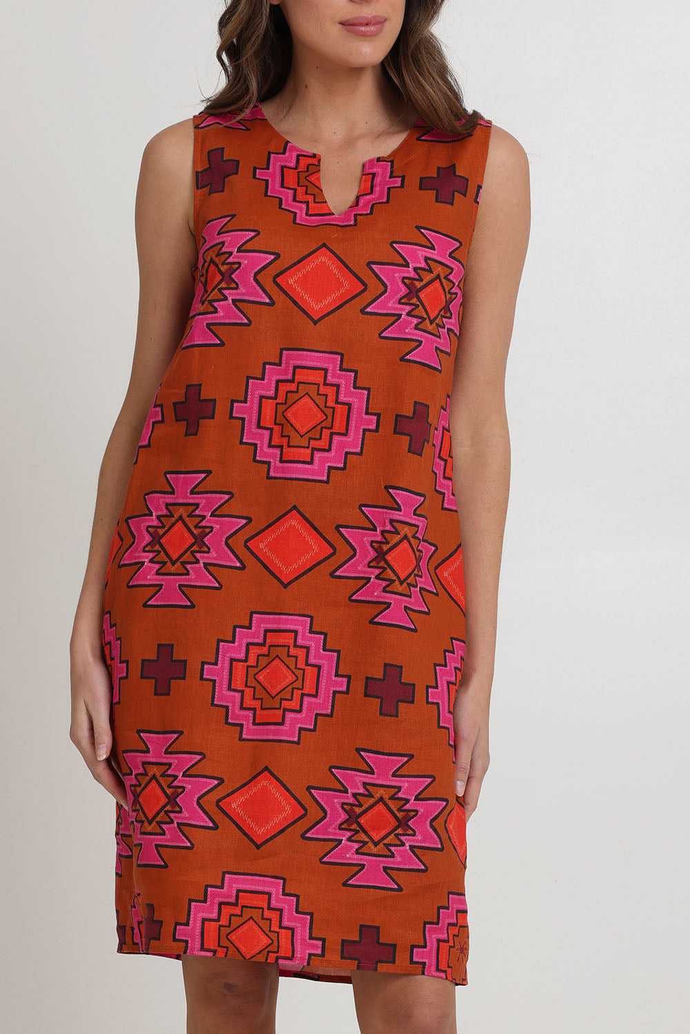 Model Madeline wearing size 10 of the Sunin colourSational Linen Dress - Palmcove, from the front, cropped image