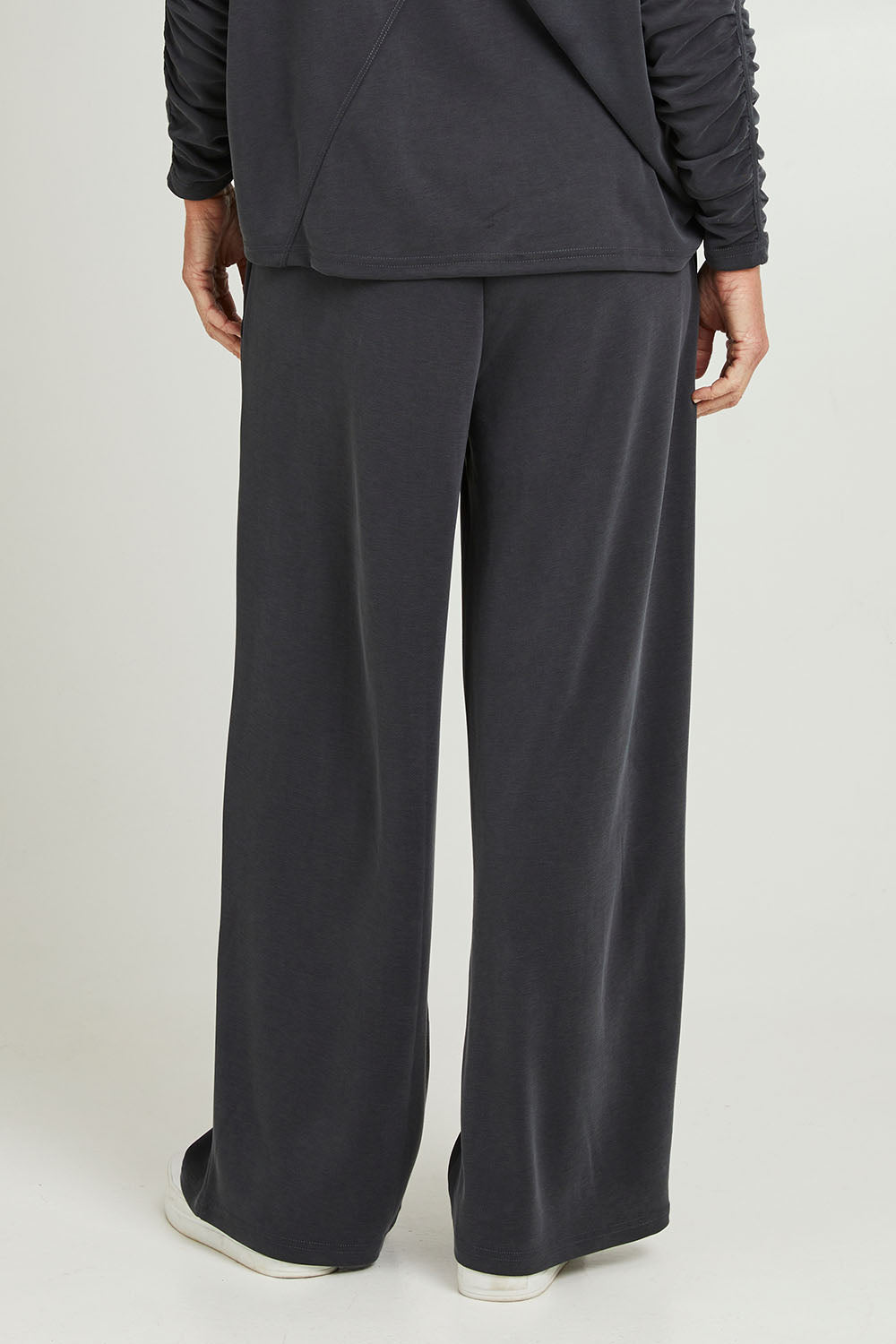Model Emma wearing size S of the Soin colourFa So Good Pant - Kohl (Blue), from the back
