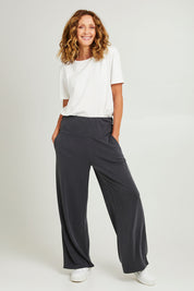 Model Emma wearing size S of the Soin colourFa So Good Pant - Kohl (Blue), from the front, showing the whole outfit