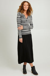Model Emma wearing size S of the Space Jam Sweater in colour Blkivory (Black), from the front, showing the whole outfit