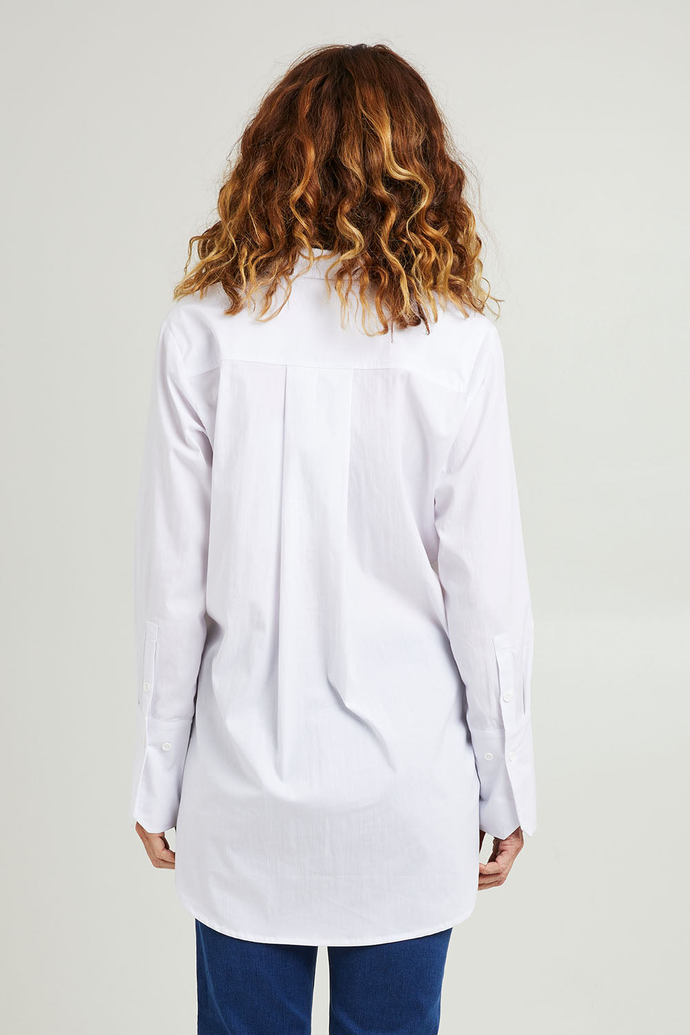 Model Emma wearing size 10 of the Hand Cuffs Shirt in colour White (White), from the back