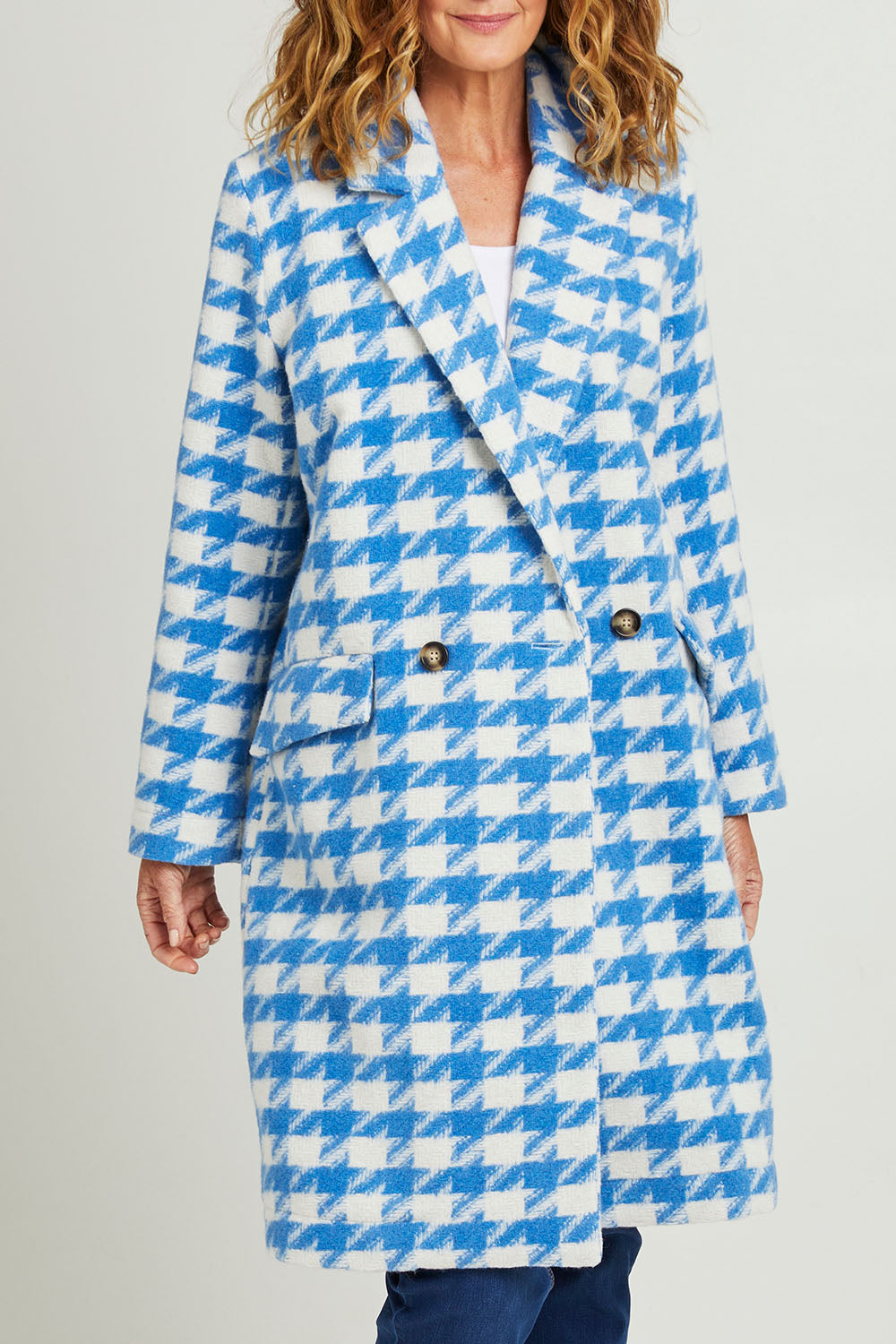 Model Emma wearing size 10 of the Play The Long Game Coat in colour Bluey (Blue), from the front, cropped image