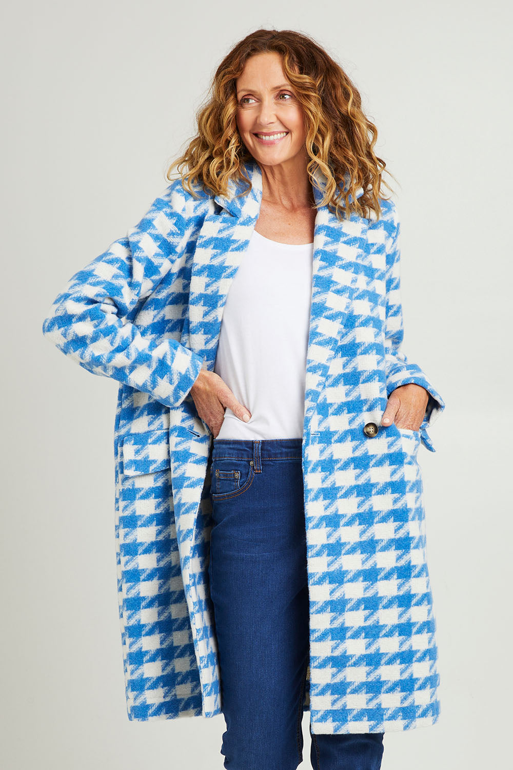 Model Emma wearing size 10 of the Play The Long Game Coat in colour Bluey (Blue), from the front, cropped image