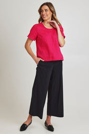 Model Olivia wearing size 10 of the Broad Appeal Pant in colour Black (Black), from the front, showing the whole outfit