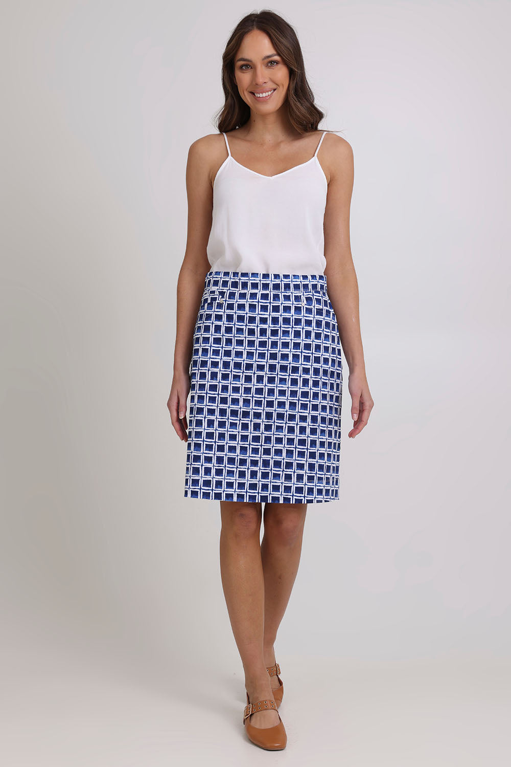 Model Madeline wearing size 10 of the Tee Off Cotton Blend Skirt Printed in colour Blockbust (Blue), from the front, showing the whole outfit