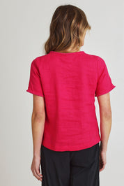 Model Olivia wearing size 10 of the Fringe Benefits Linen Top in colour Pinkflash (Pink), from the back