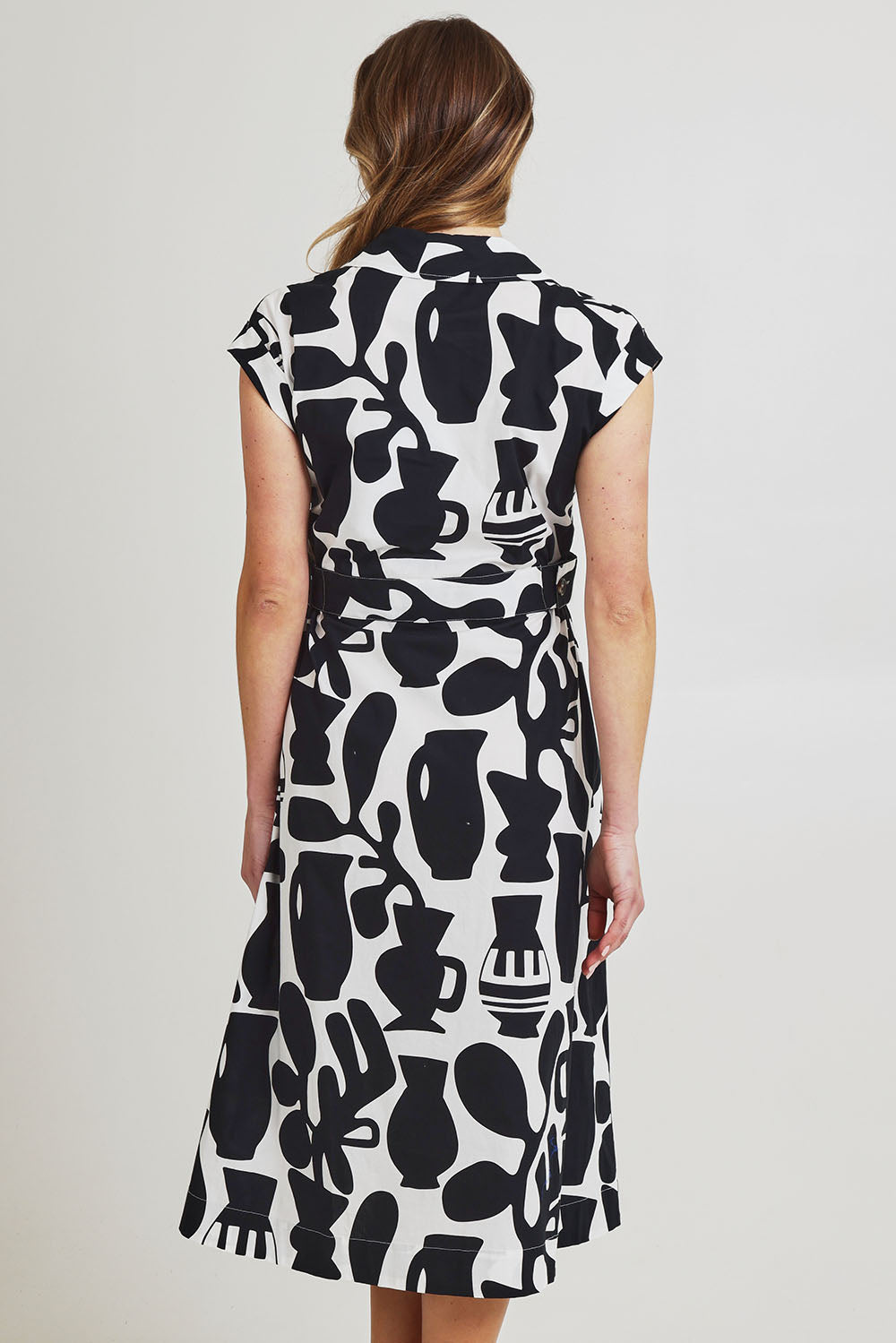 Model Olivia wearing size 10 of the Sew Chic Cotton Dress in colour Chalice (Black), from the back