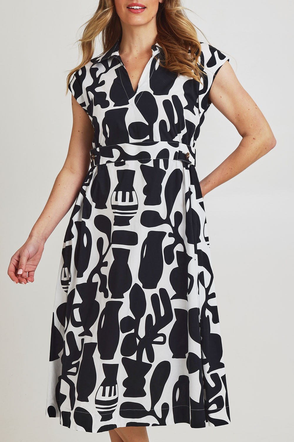 Model Olivia wearing size 10 of the Sew Chic Cotton Dress in colour Chalice (Black), from the front, cropped image