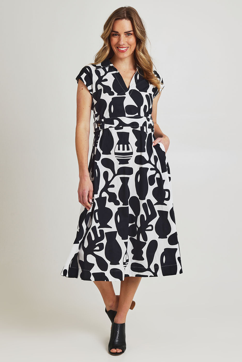 Model Olivia wearing size 10 of the Sew Chic Cotton Dress in colour Chalice (Black), from the front, showing the whole outfit