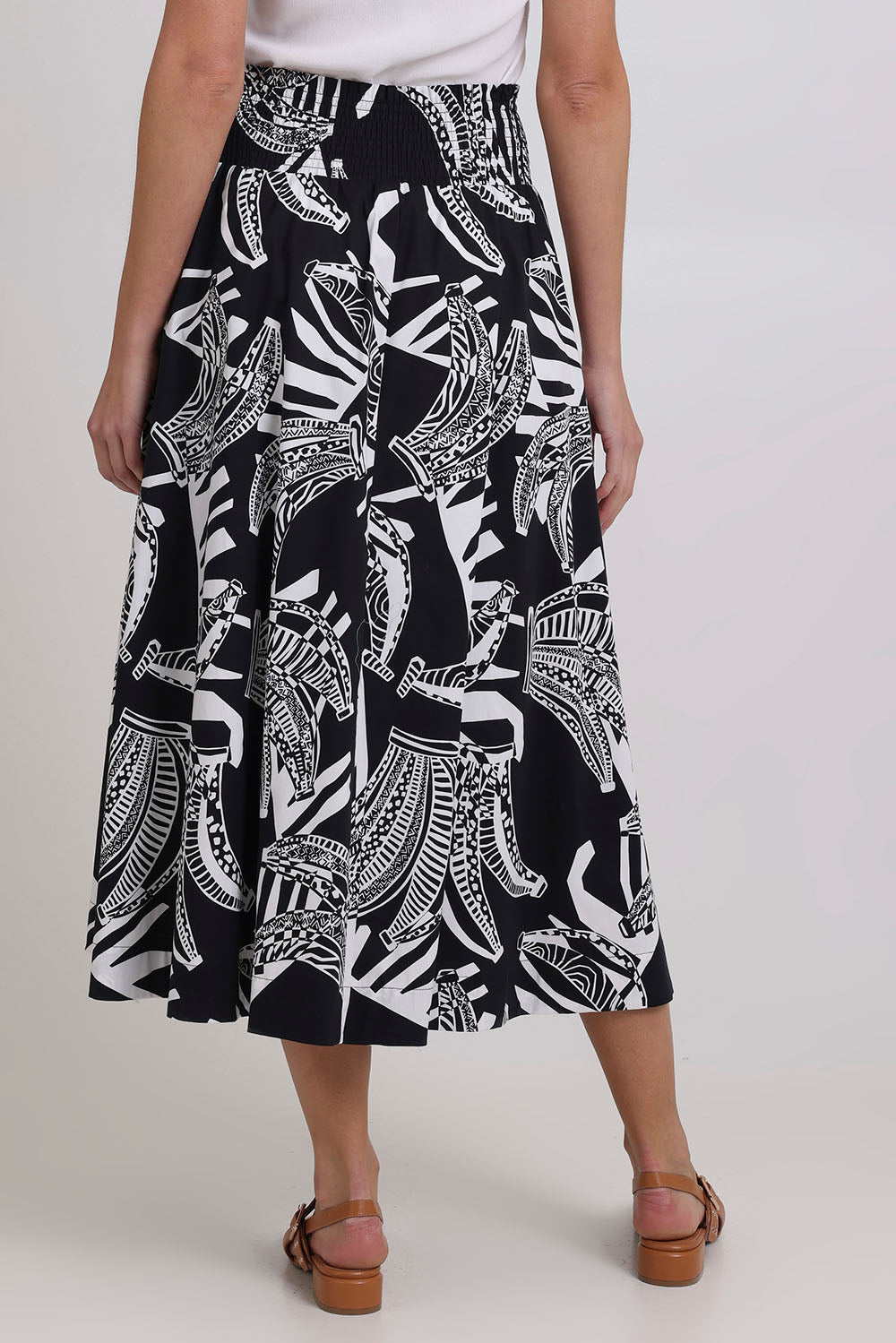 Model Madeline wearing size 10 of the Skirted Ahead Cotton Skirt in colour Bananas (Black), from the back