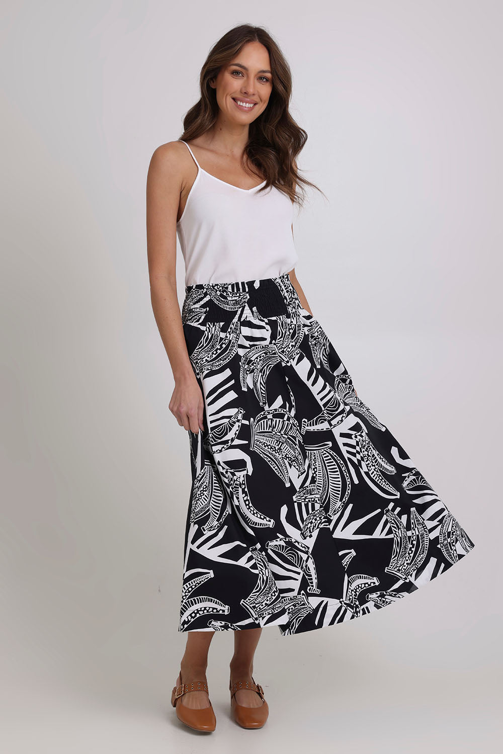 Model Madeline wearing size 10 of the Skirted Ahead Cotton Skirt in colour Bananas (Black), from the front, showing the whole outfit