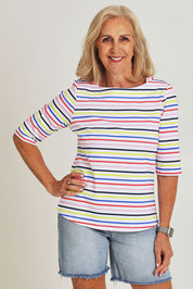 Model Sandy wearing size S of the Even Keel Cotton Top in colour Multistrip (Pink), from the front, cropped image