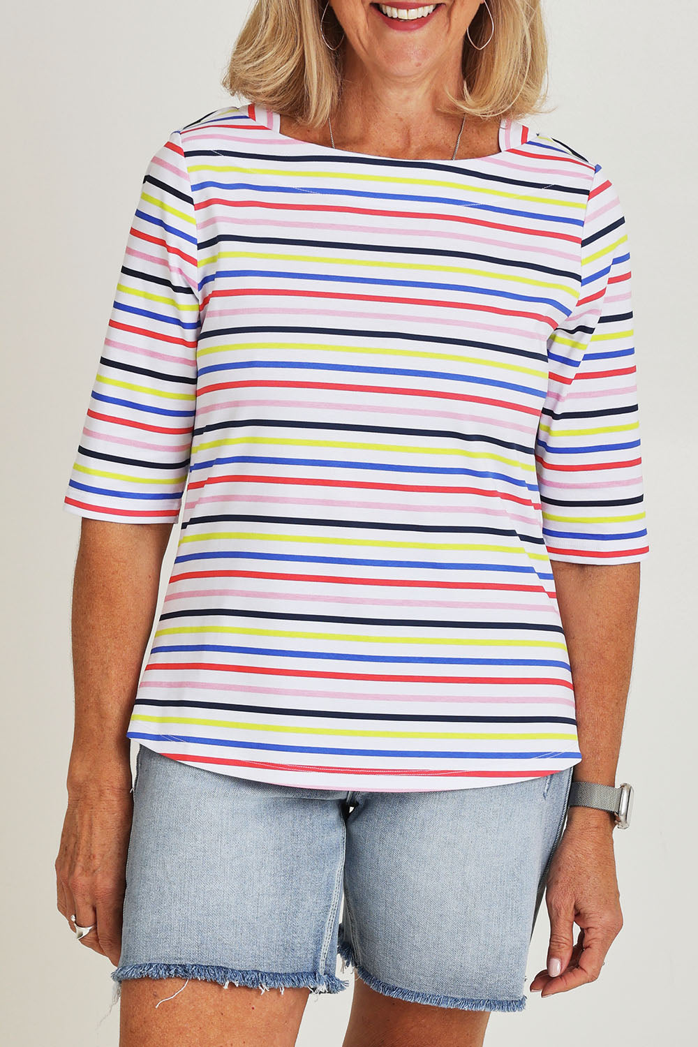 Model Sandy wearing size S of the Even Keel Cotton Top in colour Multistrip (Pink), from the front, cropped image